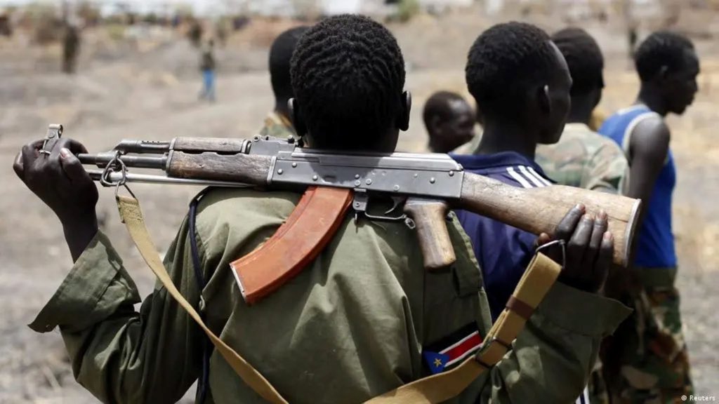 Boys handed rifles instead of books